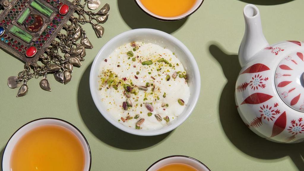 Firnee · Homemade custard made with sweet milk,  cinnamon, rose water and cardamon. Garnished with minced pistachios.