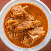 Goat Curry · Goat cooked with curry and spices.