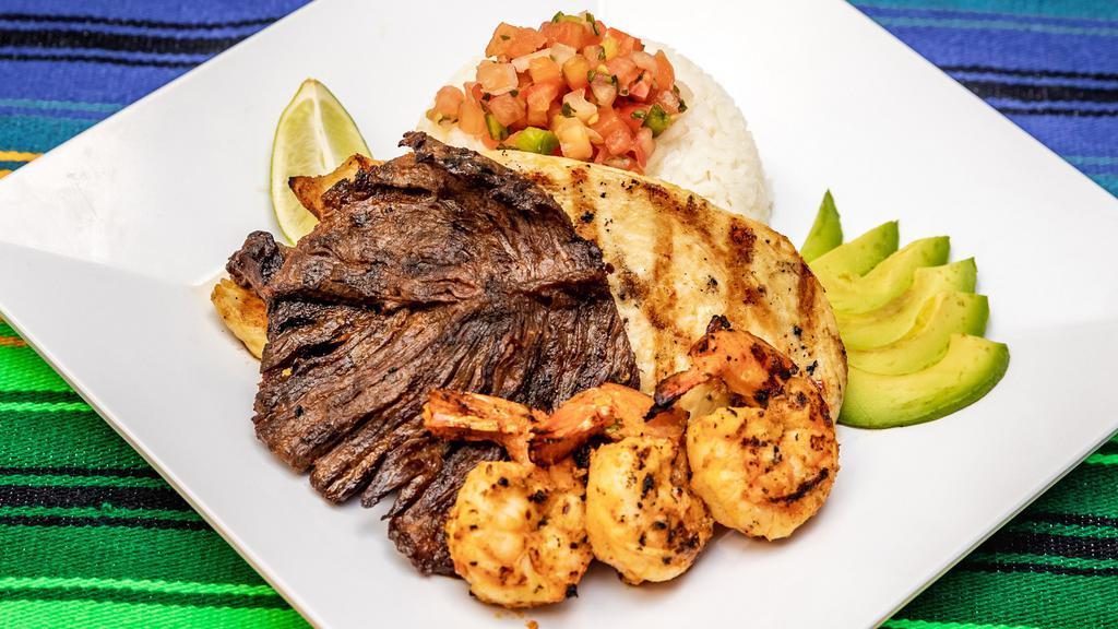 Mar Y Tierra / Surf & Turf · Carne asada, camarones, pollo, arroz, frijoles, chimol, ensalada, y aguacate. Servido con tortillas hechas a la orden. / Grilled steak, shrimp, grilled chicken breast, pico de gallo, green salad and avocado with tortillas made to order.