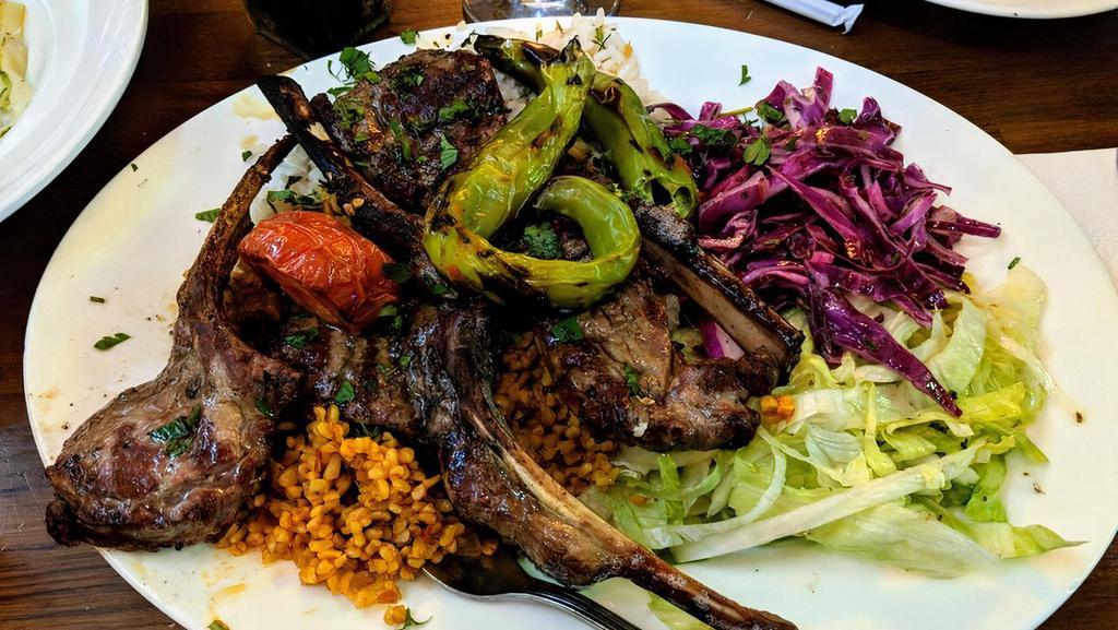 Lamb Chops · Four pieces of grilled baby lamb chops served with salad and rice.