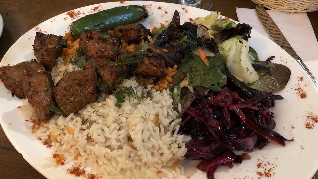 Lamb Sautee · Chunks of lamb grilled to delight on skewers served with salad and rice.