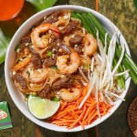 Surf & Turf Pad Thai · Stir-fried rice noodles with shrimp, chicken, scallions, bean sprouts, scrambled egg, and cr...