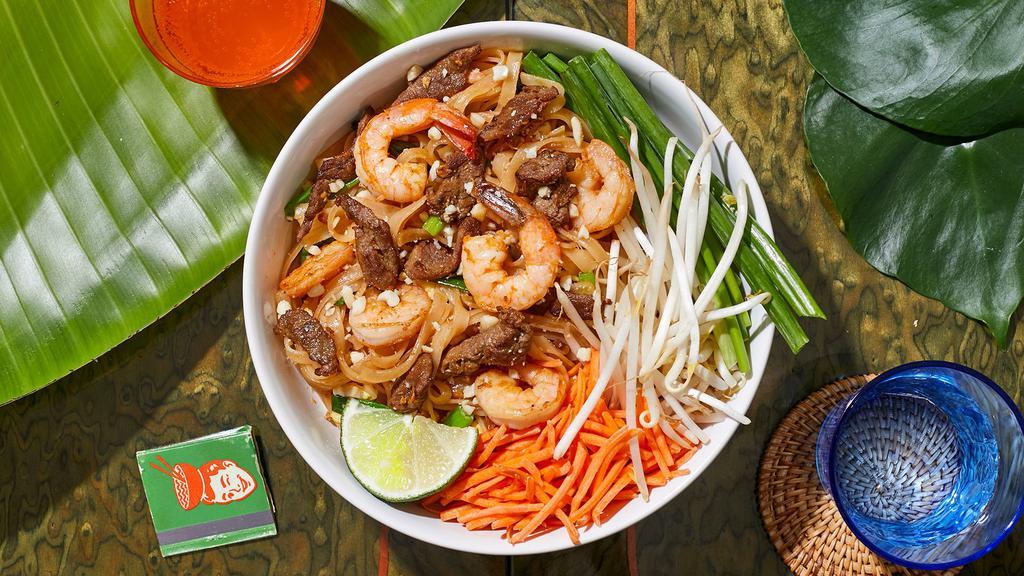 Surf & Turf Pad Thai · Stir-fried rice noodles with shrimp, chicken, scallions, bean sprouts, scrambled egg, and crushed peanuts.