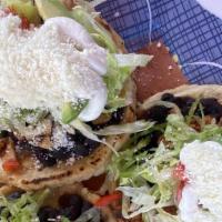 Sopes · 3 thick small tortillas covered with any type of meat topped with lettuce, tomato, cream che...