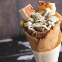Steak Arepacone · Steak cone with grilled cheese and sauce.