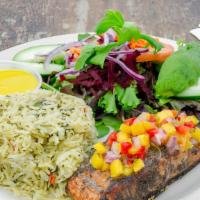 Grilled Jerk Salmon · Topped with tropical mango salsa and served with basmati spinach rice pilaf cooked with coco...