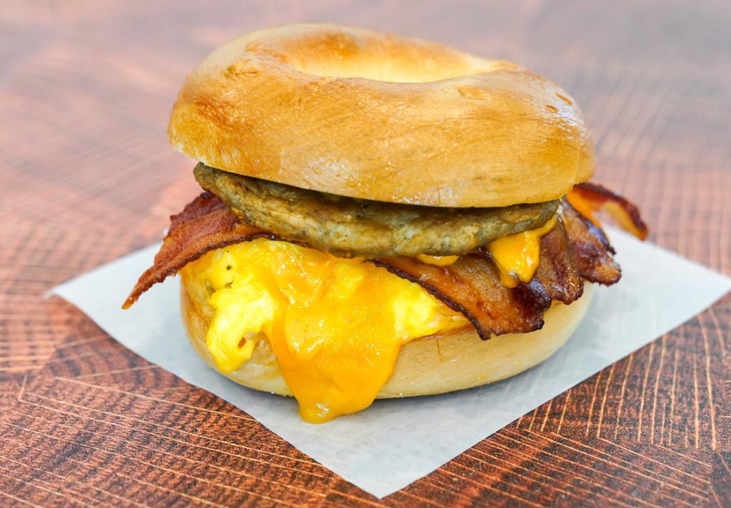 Big Breakfast Bagel · Choice of Bagel, 2 fresh cracked cage-free scrambled eggs, melted Cheddar cheese, bacon, breakfast sausage, grilled onions and Sriracha aioli