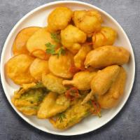 Veggie Pakora Player · Assorted vegetables dipped in a light batter and fried until golden brown.