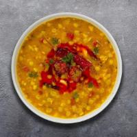 Yellow Dal Tadka · Split pea lentil cooked with garlic, tomato, mustards, and curry leaves.