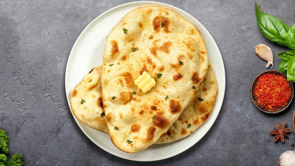 Butter Me Up Naan · Freshly baked bread in a clay oven garnished with butter.