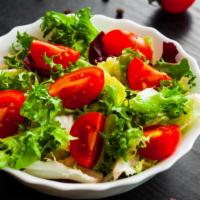 Garden Salad · Fresh romaine, tomatoes, carrots, cucumber, corn, and avocado.