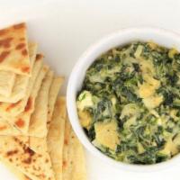 Greek Style Spinach Dip · Served with artichoke and feta.