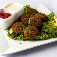 Falafel · Fried balls of finely ground chickpeas, onions, parsley, garlic and spices. 6 Pcs.