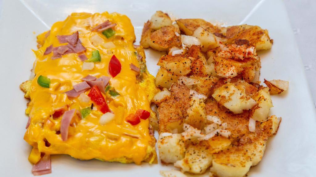 Western Omelette · Ham, peppers, and onions. Served with home fries and choice of toast.