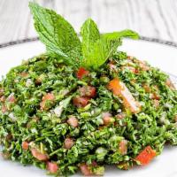Tabbouleh · A fresh parsley salad with cracked wheat, scallion, and tomato. Seasoned with olive oil, lem...