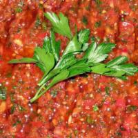 Ezme · A finely chopped mix of tomatoes, bell peppers, onions, garlic, parsley, walnut, and red pep...