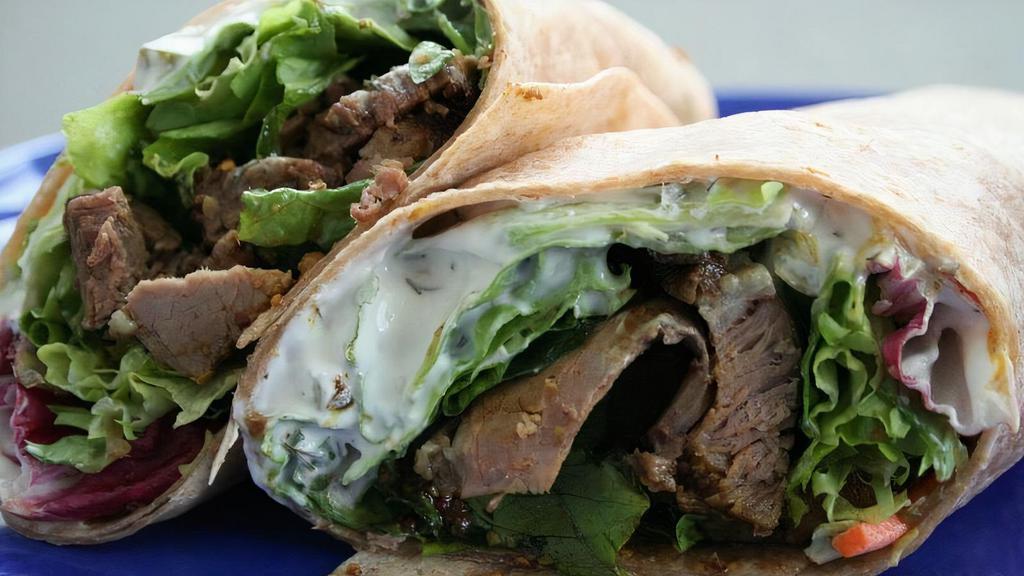 Lamb Gyro Sandwich · Thinly sliced lamb gyro served with lettuce, tomatoes, and onions.