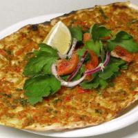 Lahmacun (2 Pc) · A Turkish styled pizza-flat bread topped with ground lamb and chopped garden vegetables.