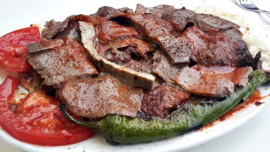 Iskender Kebab · Doner kebab served over sautéed homemade bread, topped with fresh tomato sauce and served with yogurt.