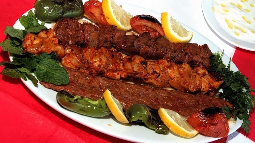 Mix Adana Kebab · Char-grilled chicken and lamb skewers seasoned with Turkish spices and served with rice and salad.