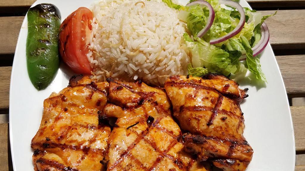 Chicken Chops · Char-grilled chicken thighs served with rice and salad.