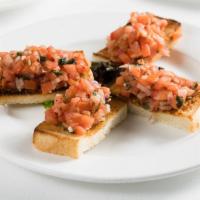 Bruschetta Al Pomodoro · Fresh tomatoes, olive oil, and garlic. Served on toasted bread.