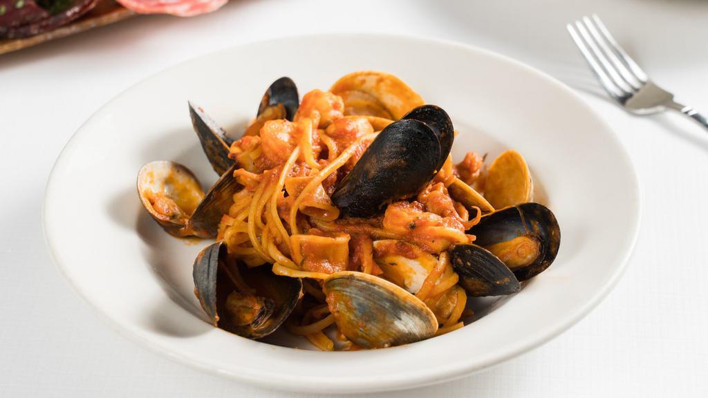 Linguine Frutti Di Mare · Mixed seafood (shrimp, mussels, clams, and calamari) on a bed of linguini with tomato sauce.