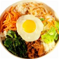 Bi Bim Bap · Rice with vegetables, beef and a fried egg all deliciously seasoned.