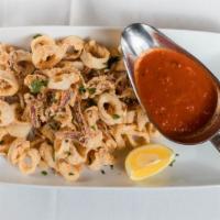 Fried Calamari · Famiglia style. Tossed with cherry peppers and a marinara sauce.
