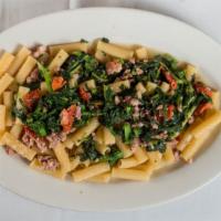 Rigatoni La Famiglia · Homemade crumbled sweet sausage with broccoli rabe and sun-dried tomatoes in a garlic and oil.