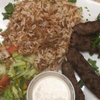 Kofta Kabab Over Rice · Served with garden salad and tahina sauce.