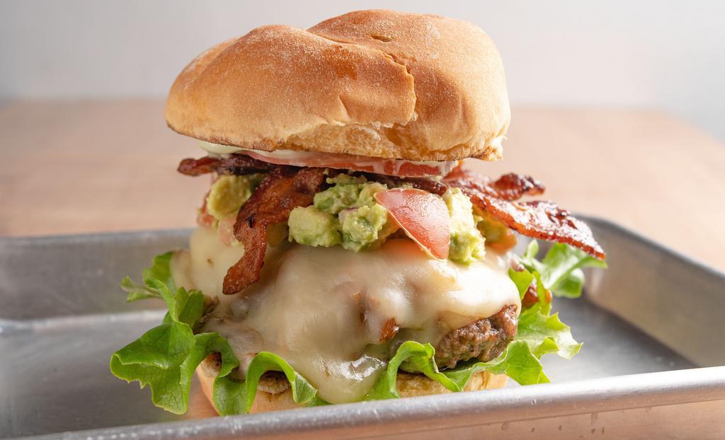 Guac-Zilla Burger · A burger topped with bacon, Pepper Jack cheese, guacamole, lettuce, tomato, and wasabi mayo. All burgers cooked medium unless requested otherwise. Option to order Nature's Own farm grass-fed beef.