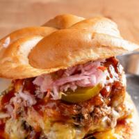 Southern Comforts Burger · A cheeseburger topped with a mac and cheese patty, pulled pork, coleslaw, pickles, and bbq s...