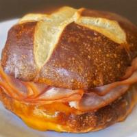 Hot Pretzel Bun Sandwich - Turkey & Cheese · Hot pretzel bun sandwich with turkey and melted cheddar cheese.