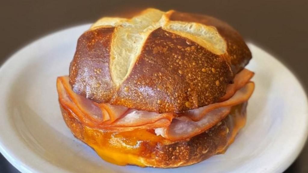 Hot Pretzel Bun Sandwich - Turkey & Cheese · Hot pretzel bun sandwich with turkey and melted cheddar cheese.