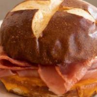Hot Pretzel Bun Sandwich - Ham & Cheese · Hot Pretzel bun sandwich with ham and melted cheddar cheese.