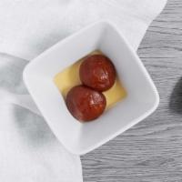 Gulab Jamun · Cream balls dipped in syrup and rose water.