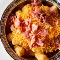Large Cheesy Bacon Tots · Crispy, golden tots topped with cheddar cheese and bacon. Served with ketchup on the side.