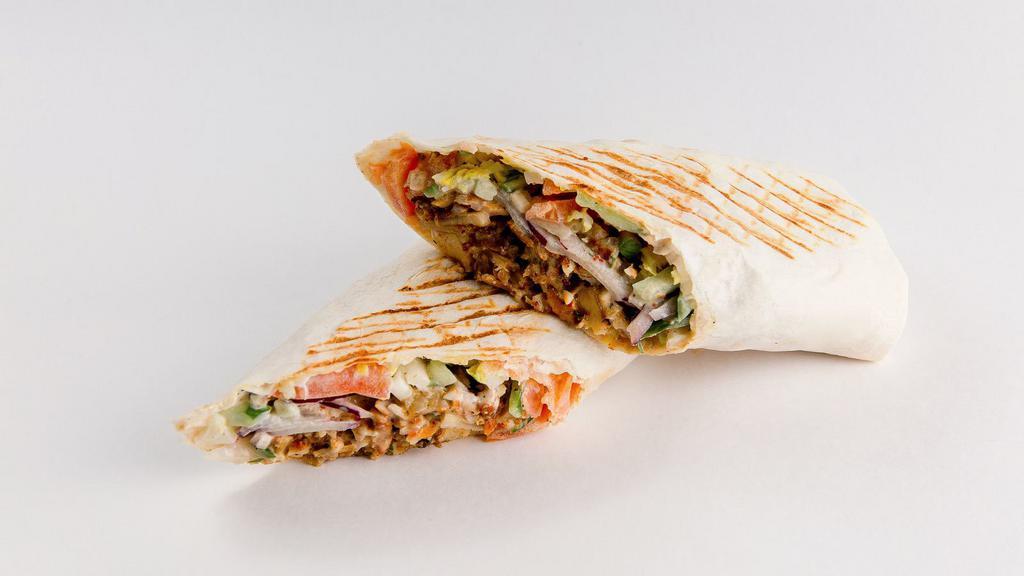 Falafel Gyro · Crispy falafels, hummus, lettuce, tomatoes and onions wrapped in pita bread.
