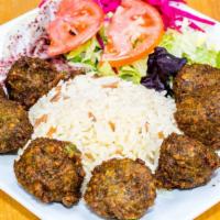 Falafel Over Rice · Crispy falafels, hummus, lettuce, tomatoes and onions on bed of rice.