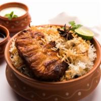 Fish Over Rice · Exquisite fish with mediterranean spices over bed of rice, served with salad and sauce on top.