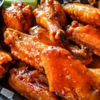 Mild Wings - Bone-In · Classic bone-in wings fried, topped with Mild hot sauce, cooked to order and perfectly crisp.