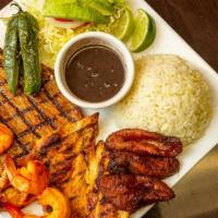 Pechuga Con Camarones · Servido con arroz, frijoles, ensalada, platanos y aguacate. / Grilled chicken breast and shr...