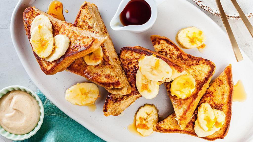 Banana Bread French Toast (3 Slices) · 3 slices of banana bread french toast with topped with sliced bananas