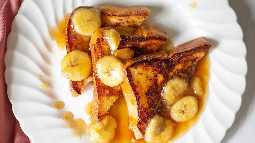 Banana Foster French Toast (3 Slices) · 3 slices of french toast with warm foster sauce and topped with sliced bananas
