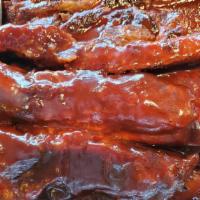 Bbq Ribs · tender off the bone pork bbq ribs comes with rice beans and plantains