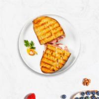 Return Of The Turkey Panini · Sliced turkey, melted cheese, and tomato on your choice of toasted bread.