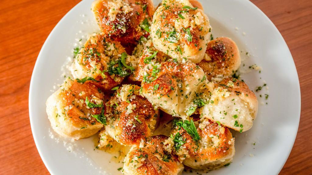 Garlic Knots · A classic snack, our garlic knots
are strips of pizza dough tied in a
knot, baked, and then topped
with melted butter, garlic, and
parsley.