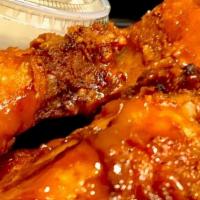 Mojo Wings · 6 mild wings in a mango-buffalo glaze, garnished with scallions and served with homemade blu...