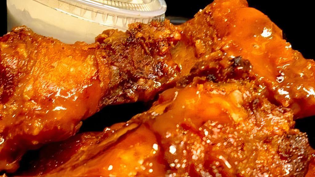 Mojo Wings · 6 mild wings in a mango-buffalo glaze, garnished with scallions and served with homemade blue cheese dressing